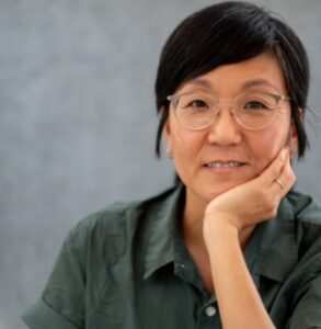 Na Young Ma, founder and selling owner of Proof Bakery in Los Angeles, smiling with her hand resting on her chin.